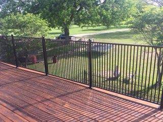 Black ornamental iron deck railing overlooking a Decatur, TX backyard