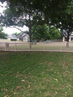 White picket-style wood fence bordering a Decatur, TX lawn